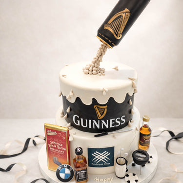 Two tier Guinness cake with a pint pouring into the top