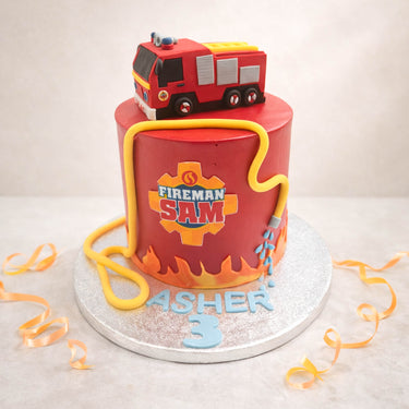 Fireman Sam birthday cake with a red fire engine on top