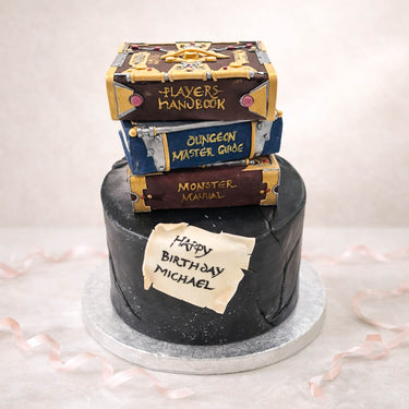Dungeons and Dragons birthday cake with a stack of handbooks on top
