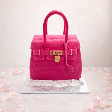 Pink designer handbag cake with a gold clasp