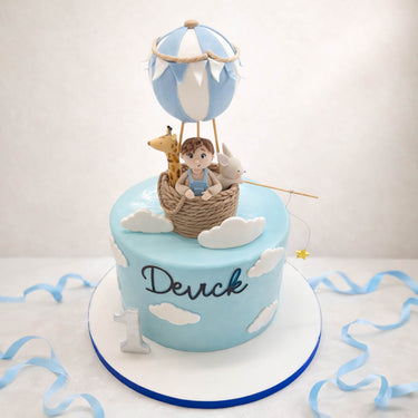 Hot air balloon cake with a teddy and a little boy in the basket