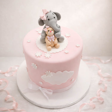 Pale pink christening cake with an elephant and a teddy