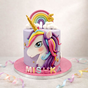 Rainbow unicorn birthday cake in pink and purple