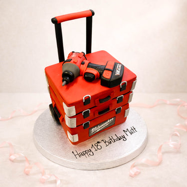 Red tool box cake with a power drill on top