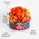 Day of the Dead Cake with a sugar skull lady design and silk flowers on top