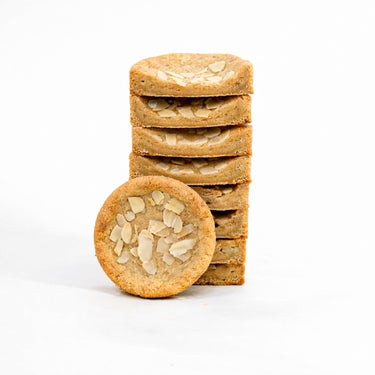 Stack of Almond Croissant Cookies topped with flaked almonds