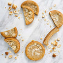 Almond Croissant Cookies, whole and halved, with flaked almonds on marble