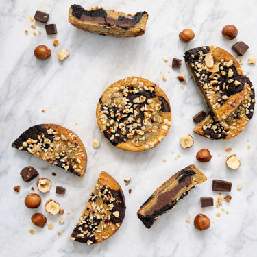 Hazelnut Marble Cookies with swirled chocolate tops and chopped hazelnuts, on marble