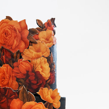 Floral Cutout Wedding Cake with orange sugar flowers cascading down black tiers
