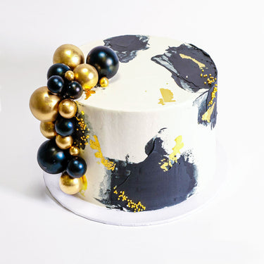 Gold Abstract Cake with white buttercream, abstract black icing, gold leaf and edible balls