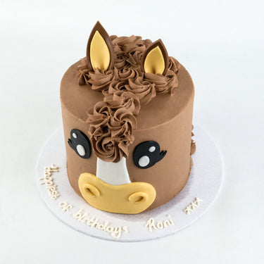 Horse Face Cake with light brown buttercream, piped mane, fondant ears, eyes and muzzle and a birthday message