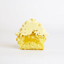 Lemon Cupcake cut in half, showing vanilla sponge with a lemon coulis centre and lemon buttercream