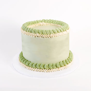 Pale green Frilly Round Cake with green and white piped ruffles