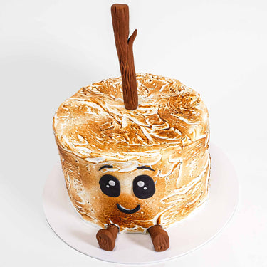 Toasted Marshmallow Cake decorated as a marshmallow on a stick, with a fondant face and feet