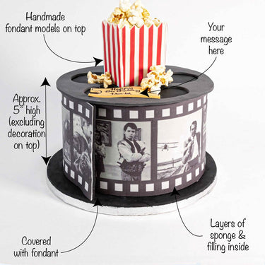Movie Cake shaped like a film reel with a popcorn box on top and a plaque for a message