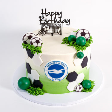 Two tone Football Cake with a club crest, football pattern, edible grass and a happy birthday topper