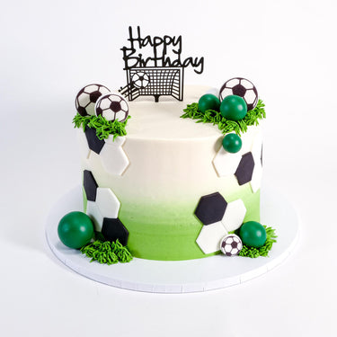 Free From Football Cake with fondant football panels, green piped grass and a club badge