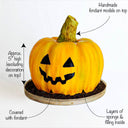Pumpkin Cake covered in orange fondant with a jack o'lantern face and a fondant stalk