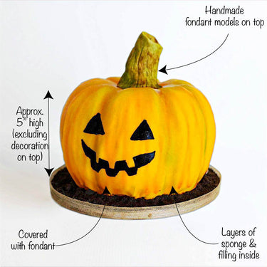 Pumpkin Cake covered in orange fondant with a jack o'lantern face and a fondant stalk