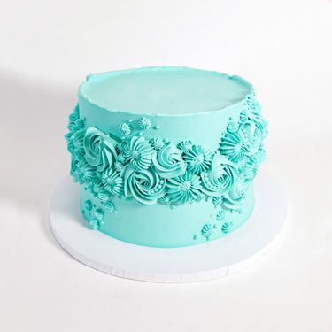 Ripple Cake with smooth aqua buttercream and piped swirls, rosettes and stars