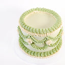 Pale green Frilly Round Cake with piped ruffles and scalloped garlands in green and cream