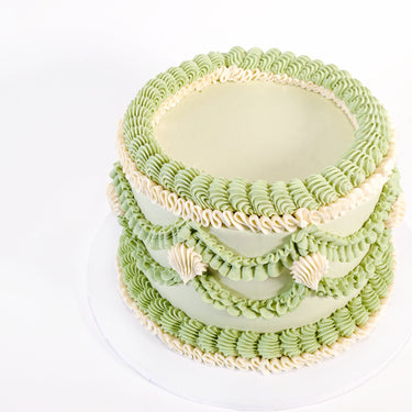 Pale green Frilly Round Cake with piped ruffles and scalloped garlands in green and cream