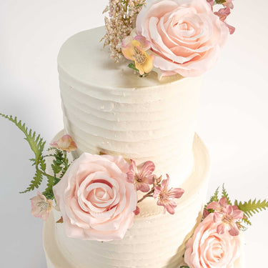 Rustic Wedding Cake with smooth white buttercream, pale pink roses and greenery
