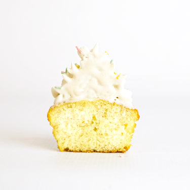 Vanilla Cupcakes with white buttercream swirls and colourful sprinkles