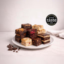 Wholesale Brownies: A plate of assorted brownies and blondies, featuring various flavors, alongside chocolate squares and chips. Includes award badge for taste excellence.