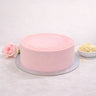 Rose and Elderflower Cake with pale pink buttercream and white sugar pearls, next to a rose