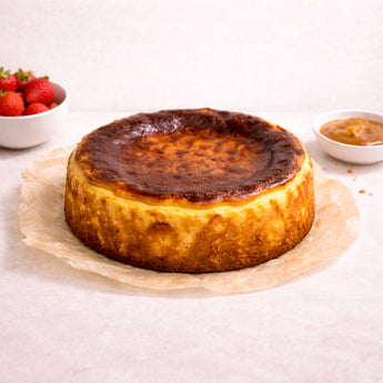 Basque cheesecake with a burnt top, with fresh strawberries and sauces