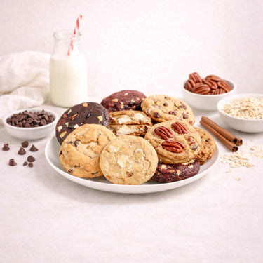 Wholesale Chunky Cookie display with assorted freshly baked cookies, a milk bottle, and bowls of ingredients like chocolate chips and pecans, highlighting premium flavors and ingredients.